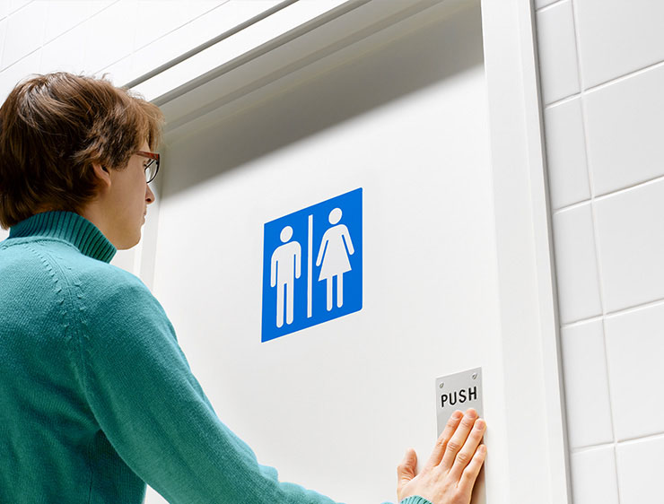 Woman entering a public restroom.