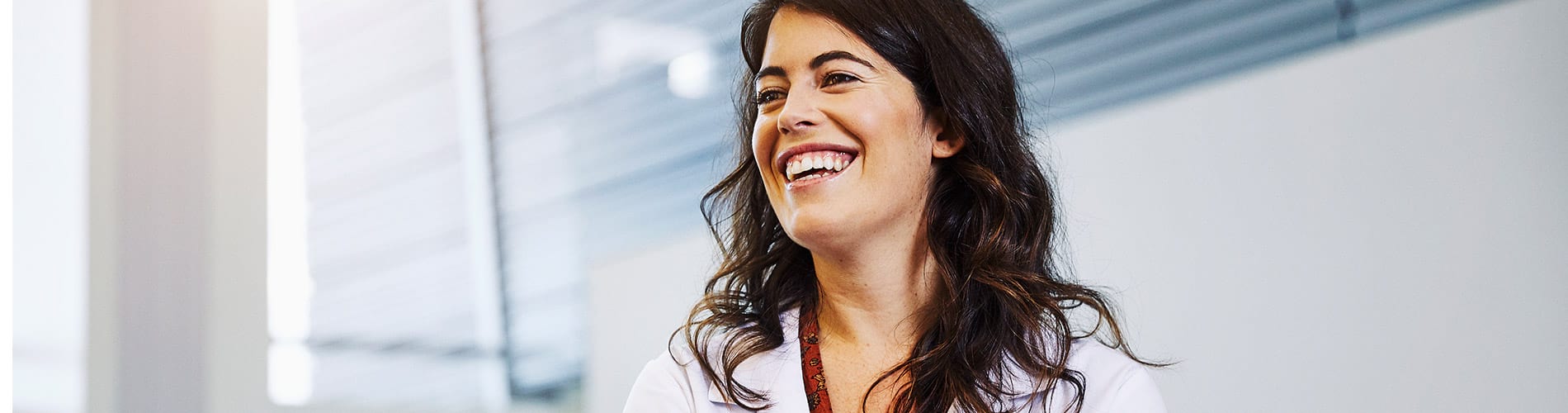A smiling female physician in a clinical setting