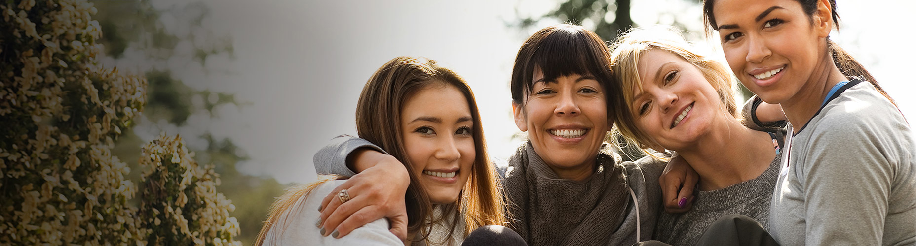 Group of healthy, middle-aged women smiling and laughing.