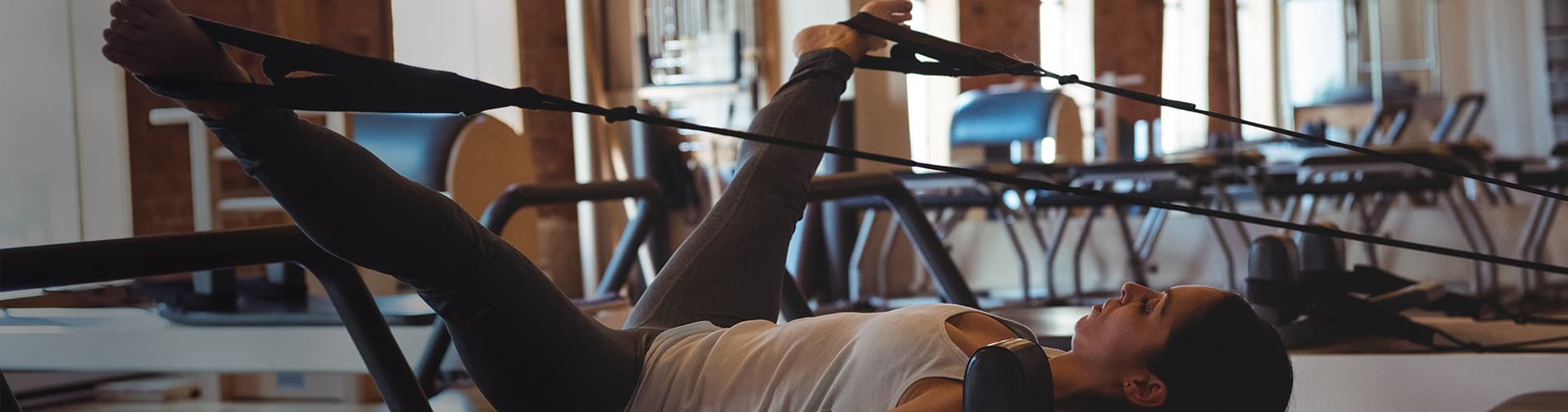 A woman performing kegel exercises at the gym