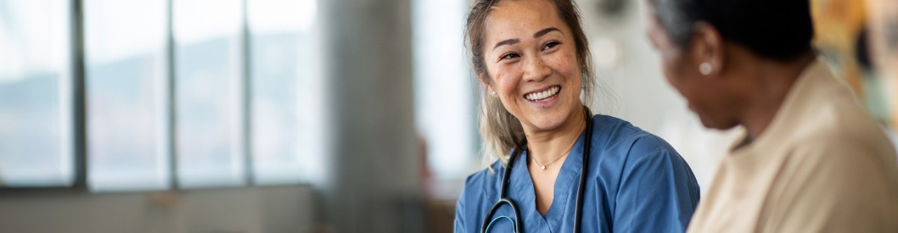 Female doctor talking to a female patient.