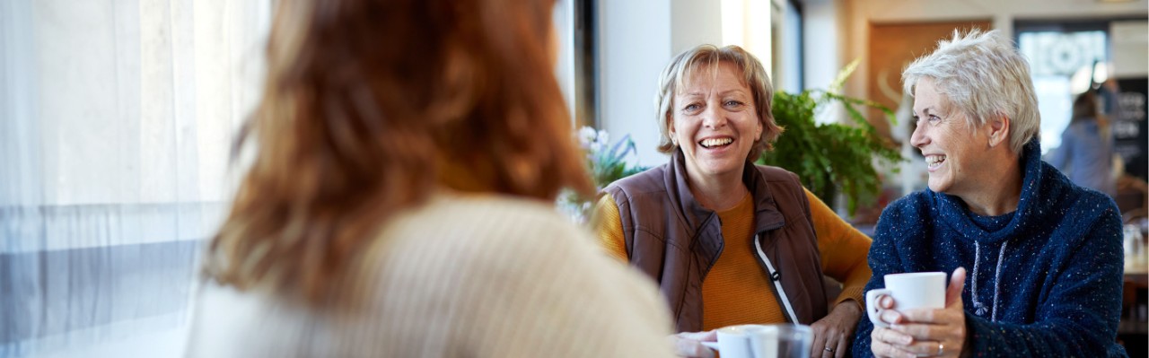 Women talking in a coffee shop.