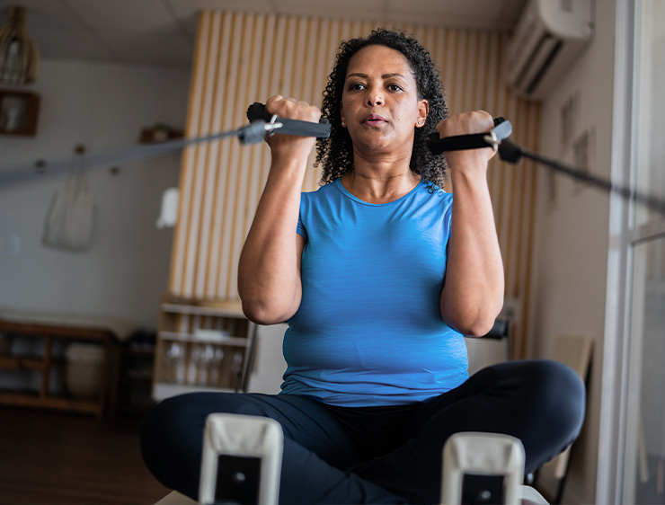 Woman working out on fitness equipment.