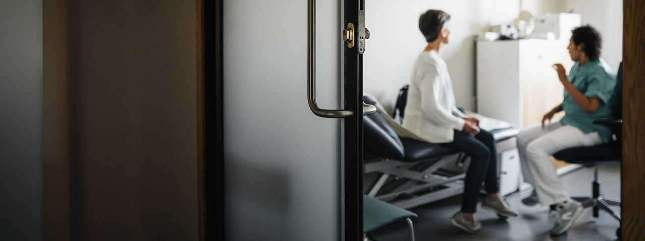 Healthcare professional talking to a patient.