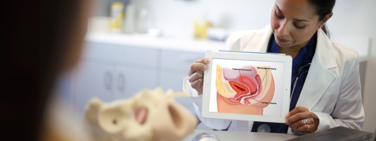 Physician showing information on a tablet with a patient.